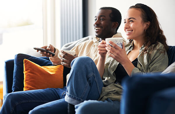 multi-ethnic-couple-on-couch_2 couple watching tv