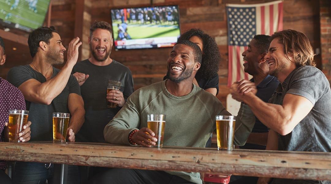 DTV-Biz-mobile-21 Group at bar watching DIRECTV